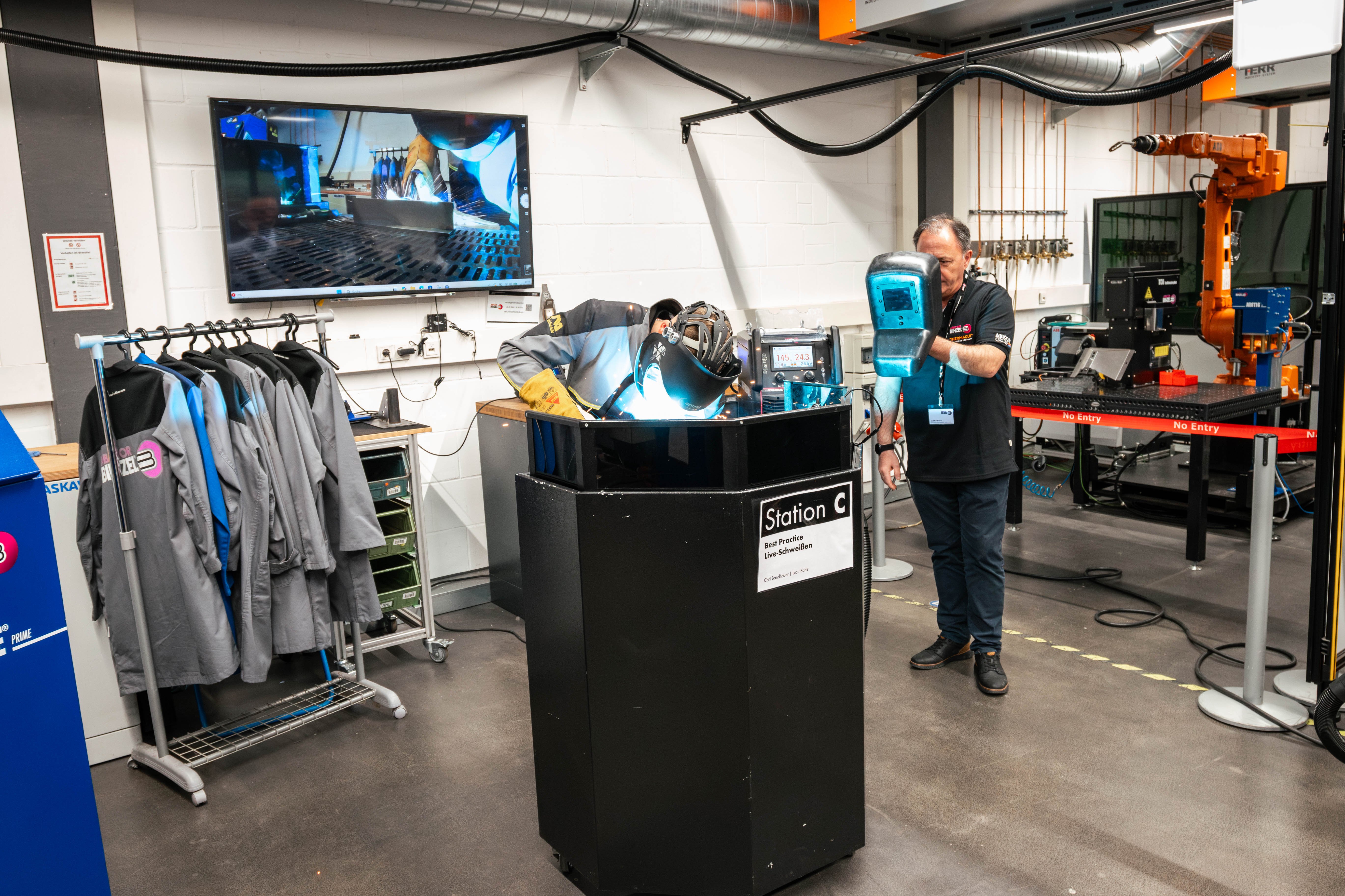 Welding workstation with a fume extraction torch during a live demonstration