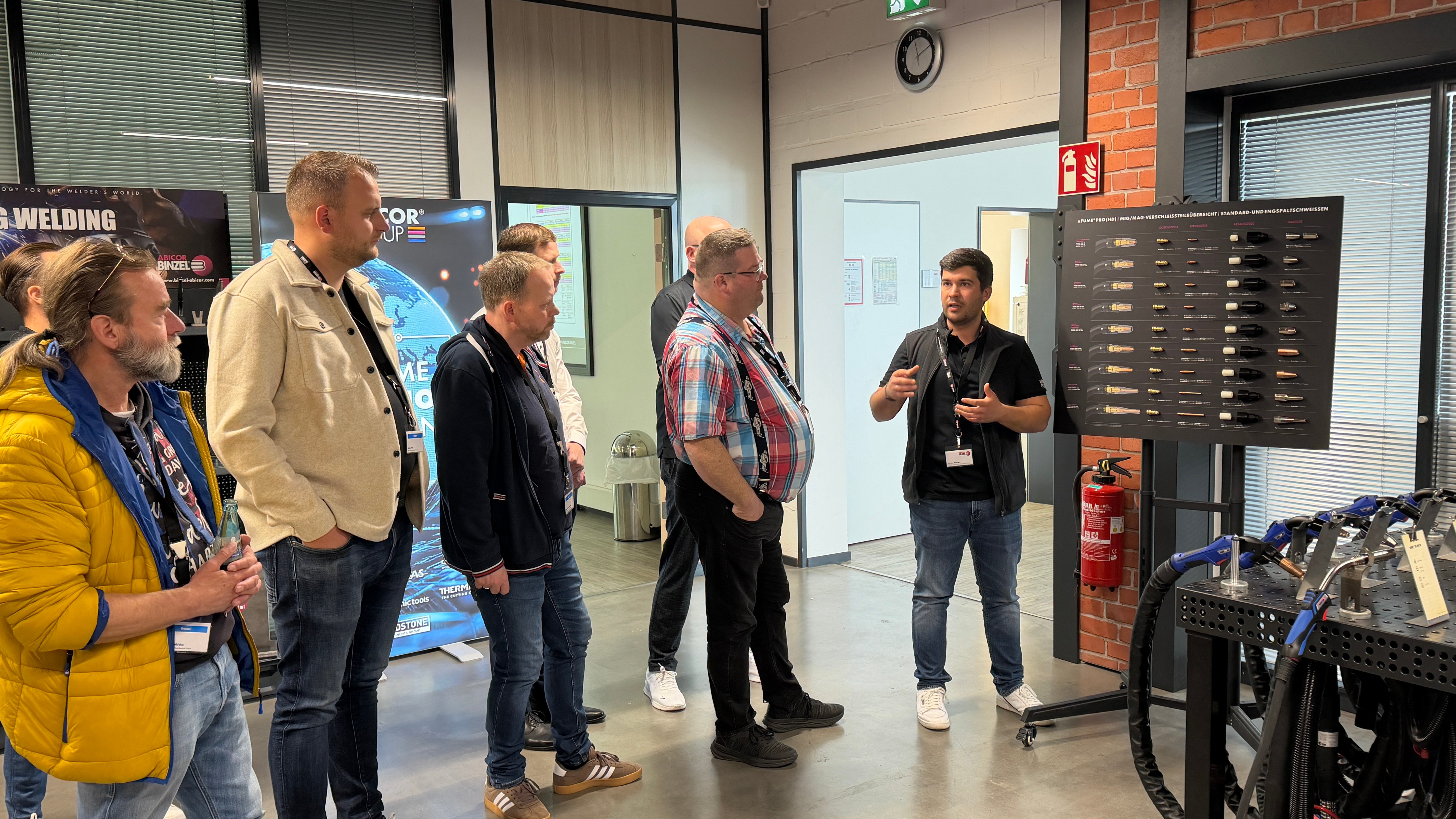 Visitors exploring fume extraction solutions in the ABICOR BINZEL showroom